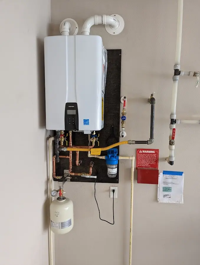 Professional plumber installing copper piping in a Elkin home